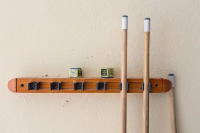 a wooden shelf on a wall with four wooden bats at Villa Amarela in Vilamoura