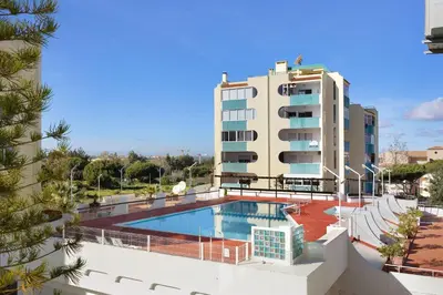 a swimming pool on the roof of a building at House Amendoeiras in Vilamoura