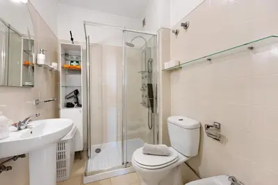 a bathroom with a toilet and a shower and a sink at House Amendoeiras in Vilamoura