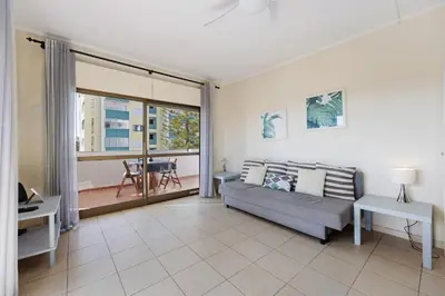 a living room with a couch and a balcony at House Amendoeiras in Vilamoura