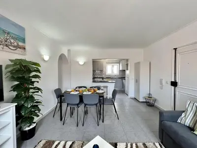 a living room and dining room with a table and chairs at Vilamoura Central 5 by Homing in Vilamoura