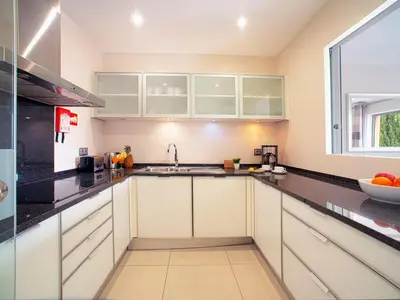 a kitchen with white cabinets and a sink at Apartment Pine Hills Turquesa by Interhome in Vilamoura