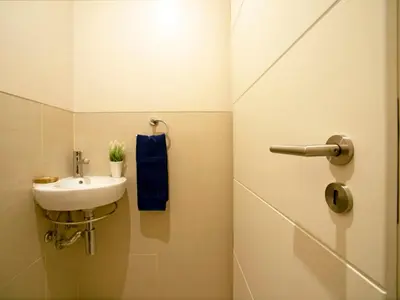 a bathroom with a sink and a blue towel at Apartment Pine Hills Turquesa by Interhome in Vilamoura