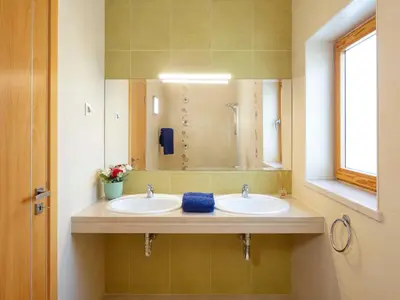 a bathroom with two sinks and a large mirror at Villa Mathilda by Interhome in Albufeira