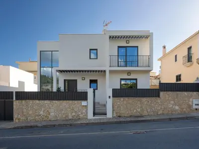 a white house with a stone wall at Villa Mathilda by Interhome in Albufeira