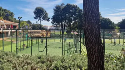 a group of people playing tennis on a tennis court at Your house at Falésia in Albufeira