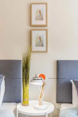 a living room with a couch and a table with a lamp at #032 T2 Idalia by Home Holidays in Albufeira
