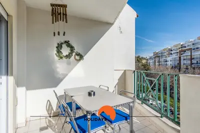 a patio with a table and chairs on a balcony at #032 T2 Idalia by Home Holidays in Albufeira