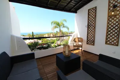 a room with a large window with a view of the ocean at Ocean View Hydrangea - 2 Bedroom Apartment at São Rafael Beach, Albufeira in Albufeira
