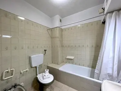 a bathroom with a tub and a toilet and a sink at Vilamoura Palm Tree With Pool by Homing in Vilamoura