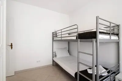 a room with two bunk beds and a door at Villa Galé in Guia