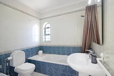 a bathroom with a tub and a toilet and a sink at Villa Galé in Guia