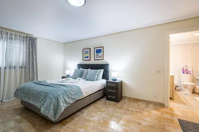 a bedroom with a large bed and a window at BeGuest Falésia Pine & Sun Apartment in Albufeira