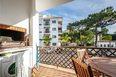 a balcony with a table and chairs and a building at BeGuest Falésia Pine & Sun Apartment in Albufeira