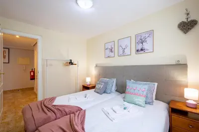 a bedroom with a bed with two towels on it at BeGuest Falésia Pine & Sun Apartment in Albufeira