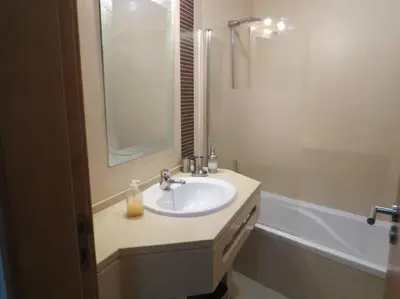 a bathroom with a sink and a mirror and a tub at Apartamento - CERRO MAR in Albufeira