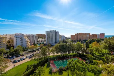 a table with apples and oranges and a glass of orange juice at Apartamento Valerie in Vilamoura