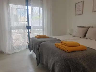 two beds sitting next to each other in a bedroom at Faro Casa da Baixa in Faro