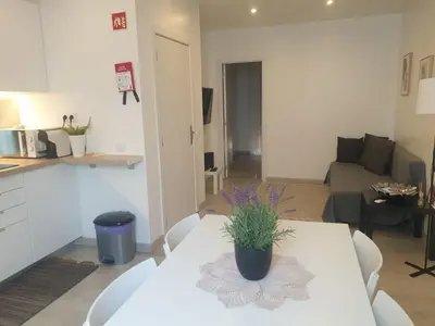 a kitchen and living room with a table with a plant on it at Faro Casa da Baixa in Faro