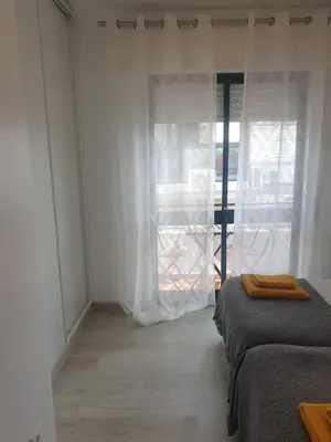 a bedroom with two beds and a window at Faro Casa da Baixa in Faro