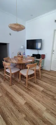 a dining room with a wooden table and chairs at Casa da Açoteia - Bright City Center Apartment with a Private Outdoor Terrace in Faro