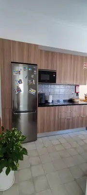 a kitchen with a stainless steel refrigerator with magnets at Casa da Açoteia - Bright City Center Apartment with a Private Outdoor Terrace in Faro