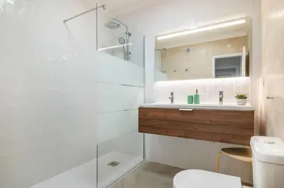 a bedroom with two beds and a mirror at Clube Albufeira: 2BR Prime Holidays Retreat in Albufeira