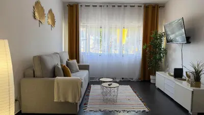 a living room with a couch and a window at Blue Wave Apartment in Albufeira