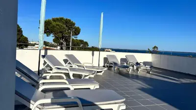 a row of lounge chairs on a roof at Blue Wave Apartment in Albufeira