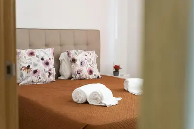 a bed with towels and pillows on it at Miral Beachside 1 - by HD Properties in Albufeira