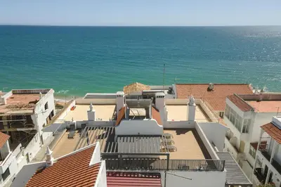 a view of the ocean from the roofs of buildings at Miral Beachside 1 - by HD Properties in Albufeira