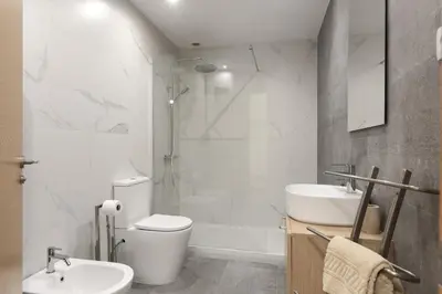 a bathroom with a toilet and a sink and a shower at Miral Beachside 1 - by HD Properties in Albufeira