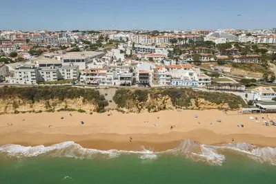 an aerial view of a beach with people on it at Miral Beachside 3 - by HD Properties in Albufeira
