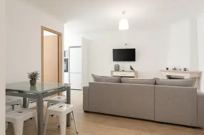 a living room with a couch and a table at Miral Beachside 3 - by HD Properties in Albufeira