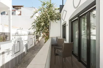 a table and chairs on the balcony of a building at Miral Beachside 4 - by HD Properties in Albufeira