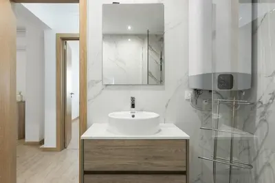 a white bathroom with a sink and a mirror at Miral Beachside 4 - by HD Properties in Albufeira