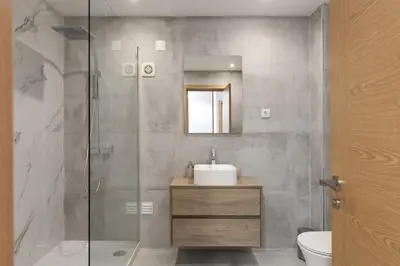 a bathroom with a sink and a glass shower at Miral Beachside 5 - by HD Properties in Albufeira