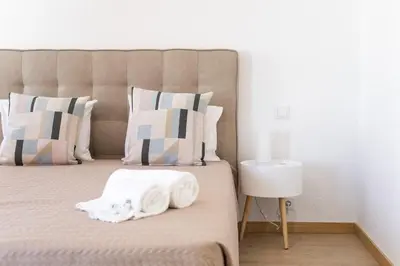 a bedroom with a bed with two folded towels on it at Miral Beachside 5 - by HD Properties in Albufeira