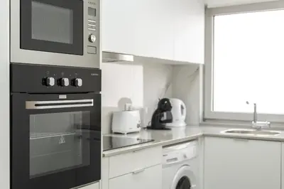 a kitchen with a stove and a microwave at Miral Beachside 2 - by HD Properties in Albufeira