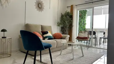 a living room with a couch and a table and chairs at Dubai Apartment in Albufeira