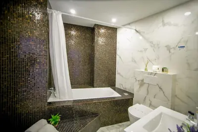 a bathroom with a tub and a toilet and a sink at Dubai Apartment in Albufeira