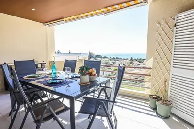 a dining room with a table and chairs on a balcony at MarGalé - Swimming Pool - Beach - BY BEDZY in Galé
