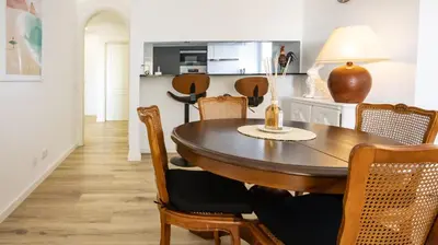 a dining room with a wooden table and chairs at MarGalé - Swimming Pool - Beach - BY BEDZY in Galé