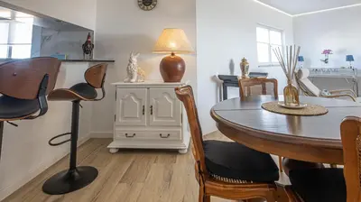 a living room with a table and chairs and a dining room at MarGalé - Swimming Pool - Beach - BY BEDZY in Galé