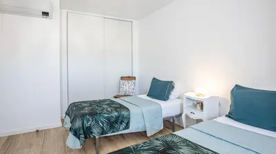 a room with two beds and a table with a lamp at MarGalé - Swimming Pool - Beach - BY BEDZY in Galé