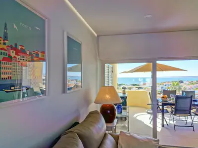 a living room with a couch and a view of the ocean at MarGalé - Swimming Pool - Beach - BY BEDZY in Galé