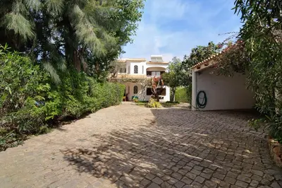 a large house with a brick driveway at Casa da Oliveira in Loulé