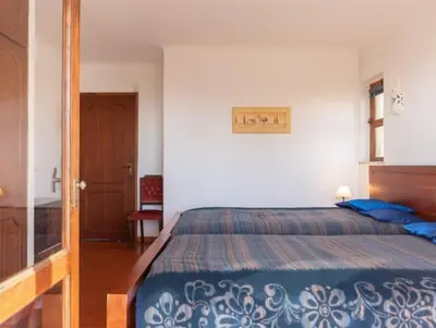 a bedroom with a bed with a blue comforter at Villa Savannah - Close to fisherman beach in Albufeira