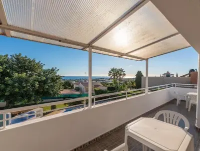 a balcony with a table and a view of the ocean at Villa Savannah - Close to fisherman beach in Albufeira