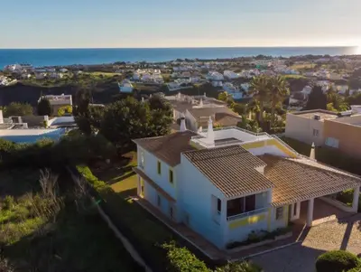 an aerial view of a white house with the ocean at Villa Savannah - Close to fisherman beach in Albufeira